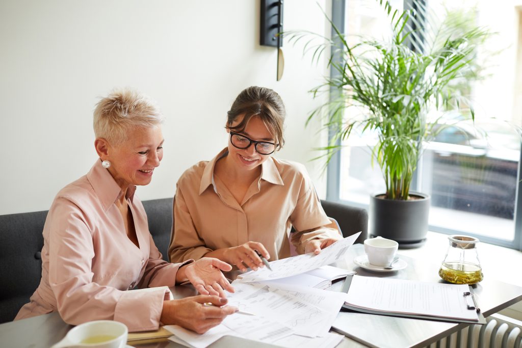 Women reviewing financial documents together