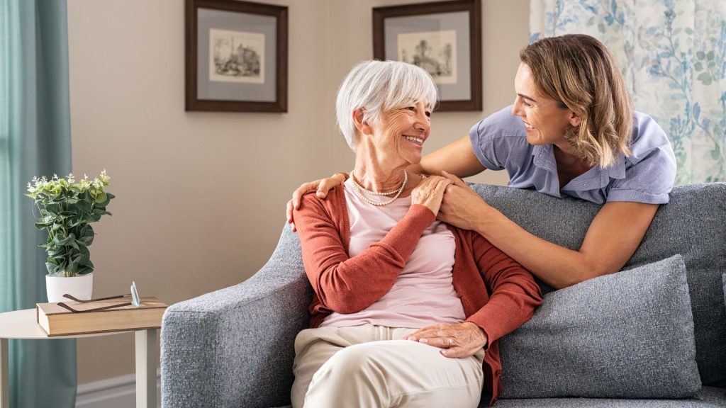 A woman in her 40s caring for her aging mother